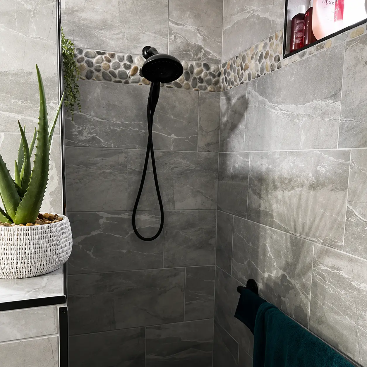 Custom tile shower with pebble accent installed by L&J in Cañon City, Colorado